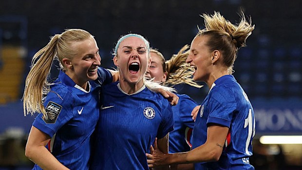 Aggie Beever-Jones of Chelsea celebrates with teammates Ellie Carpenter and Nathalie Bjoern.