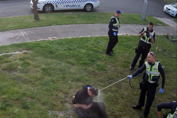 CCTV footage shows John, a disability pensioner, being hosed by a police officer.