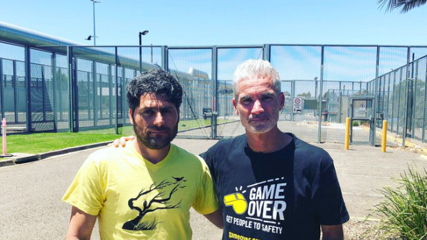 Farhad Bandesh with former Socceroo Craig Foster, after walking from detention a free man.