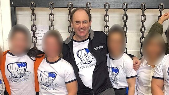 Powerlifting Australia’s national coaching director Robert Wilks, centre, has launched defamation proceedings against once of his female students.  