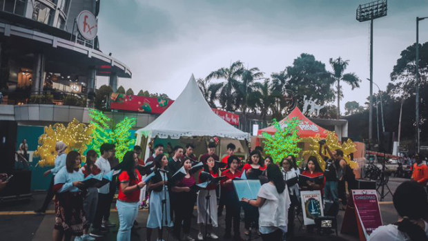 University choirs help stage the first official Christmas carols in Jakarta.
