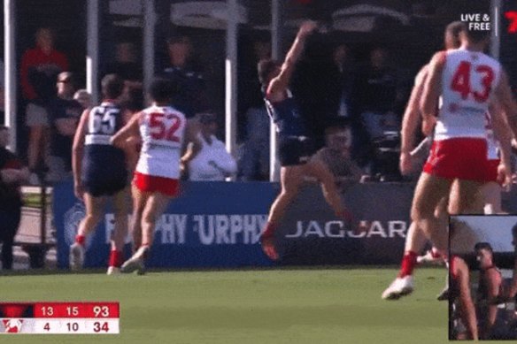 Peter Ladhams steamrolls an opponent in a VFL finals fixture.
