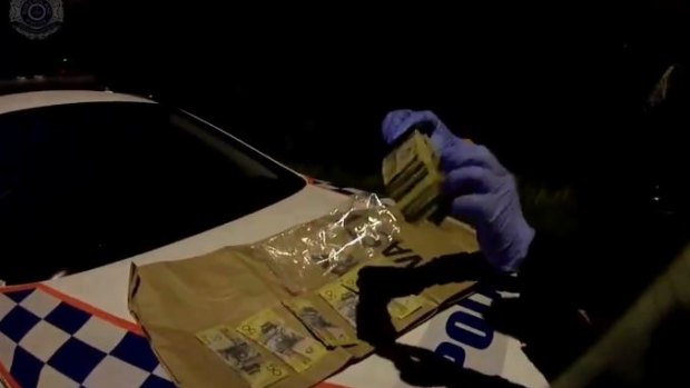 A man was arrested after allegedly driving through a red light and crashing at Burpengary before $11,000 in cash was found nearby.