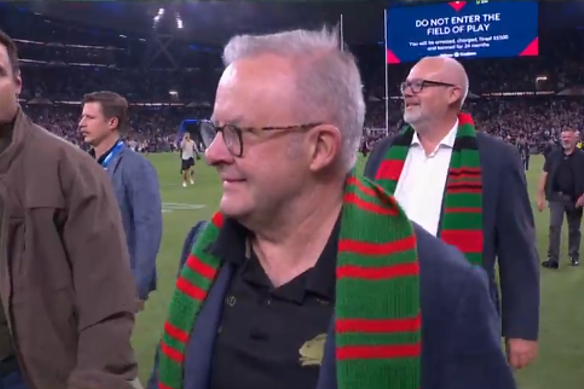 Thousands of fans stormed the field for Johnston’s record. The PM and I were two of them