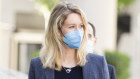 Theranos founder Elizabeth Holmes (centre) attends a court hearing in May. Her trial starts next week. 