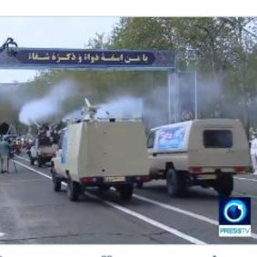 Disinfection trucks pass during a parade in Iran.