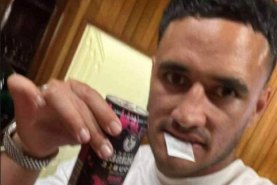 Valentine Holmes with a white bag in his mouth.