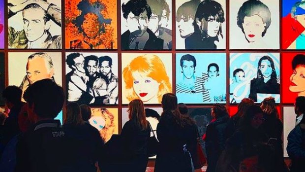 Portraits by Andy Warhol are arranged in an Instagram-like grid at an exhibition at New York's Whitney Museum of American Art.