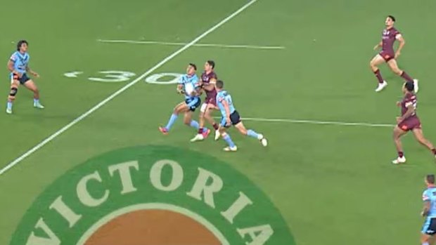 Latrell Mitchell is pushed in the back in the lead up to Queensland’s first points of the match, a penalty goal.