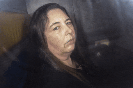 Images of Erin Patterson in the back of a police van.