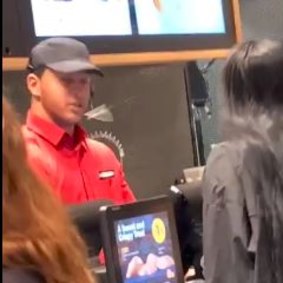 One of the teenagers spits at the restaurant worker before storming out of the outlet. 