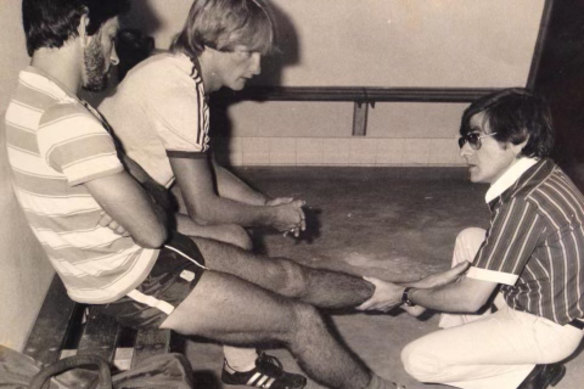 Former Parramatta Eels doctor Peter Manollaras treats Steve Ella as teammate Paul Taylor looks on.