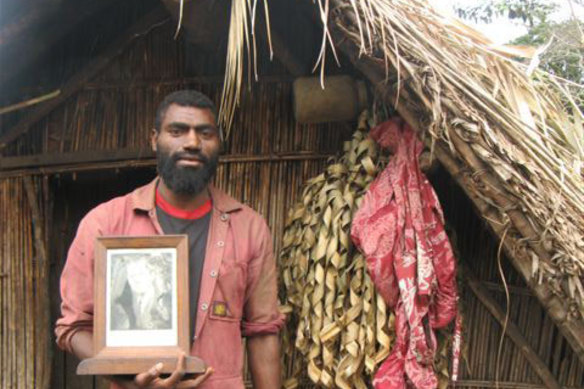 Village leader Siko Natwan with a portrait of Prince Philip. 