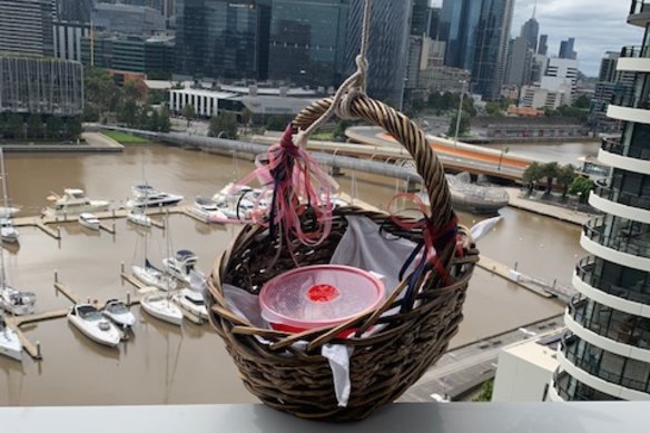 Janet Strachan's neighbours have been lowering baskets of food from their apartment down to her in a very creative way.