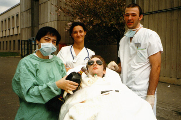 Harry’s first time outside the hospital in four months, with a nurse manually providing oxygen.