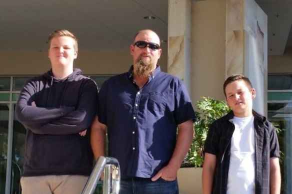 Angus, left, with father Ben and brother Kelly. 