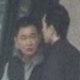 Shore party member Teng (left) with another man waiting in central Melbourne and captured on surveillance footage.