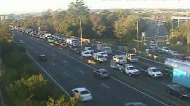 A south-facing traffic camera shows the extent of northbound delays at the Pacific Motorway's Rochedale exit at 7am.