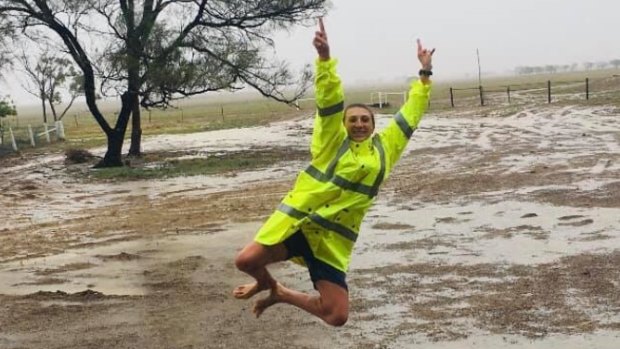 Annabel Hatch jumps for joy in soggy surrounds on her family property in the central Queensland town of Ilfracombe.