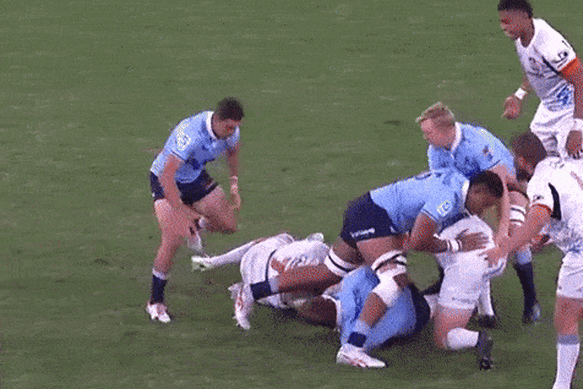 Waratahs No.10 Tane Edmed is smashed by Chiefs flanker Samipeni Finau in April.