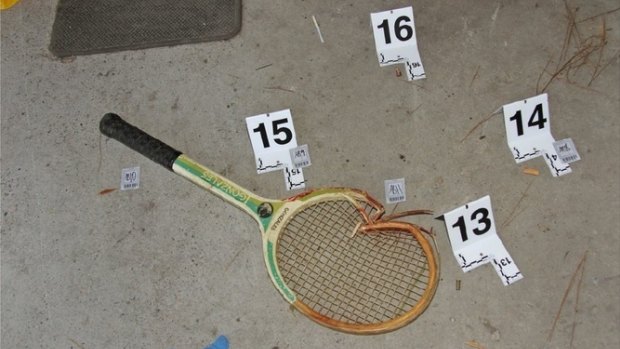 A broken and bloodied tennis racquet found at the crime scene.