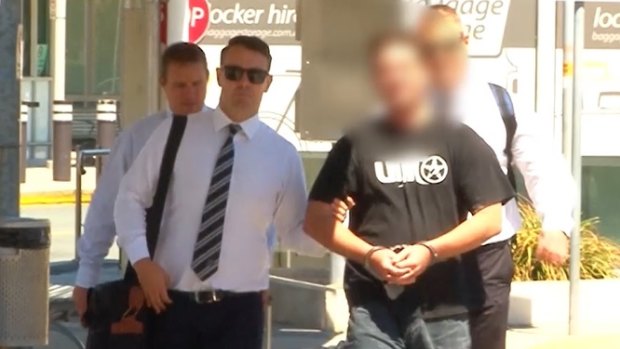 The 33-year-old man arrives in Brisbane after being extradited from Sydney.
