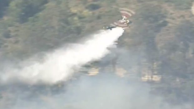 Water-bombing aircraft are helping firefighters on the ground because the terrain is challenging.