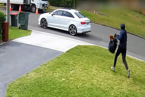 CCTV captured the man – wearing black track pants and a dark blue hoodie – running away from the Abdallah home  and hopping into a white Audi S3 Sedan, driven by an accomplice.