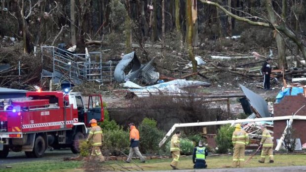 The fire brigade attends the site of a house destroyed by a tornado in Axe Creek.