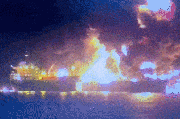 An oil tanker ablaze off the coast of Iraq after being hit by an Iranian drone.