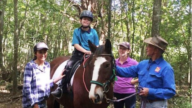 Oscar on his favourite horse, Clyde, at Brisbane's McIntyre Centre, where disabled children ride horses for therapy.