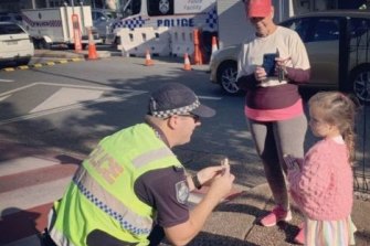 Gold Coast police gave 4-year-old girl Harpie a police cap, shirt and a toy police dog as a thank you. Harpie visited police at the border checkpoint every day with her nan to hand out lollies to thank officers for keeping everyone safe.