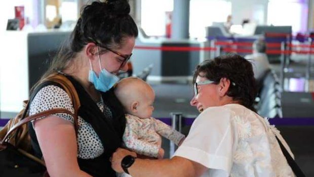 Chris Preece meets granddaughter Charlotte for the first time after the three-month-old arrived with her mother, Steph, from Melbourne. 