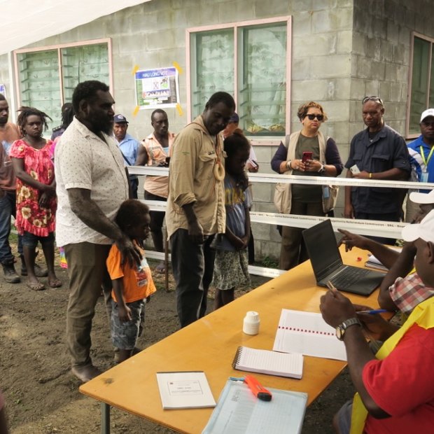 The first people to vote in the Bougainville independence referendum in the capital Arawa were the former commanders of the BRA (Bougainville Revolutionary Army) Ishmael Torama and Chris Uma, centre, standing with their children.