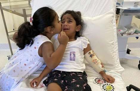 Tharunicaa and her sister Kopika in hospital on Christmas Island on June 6. 
