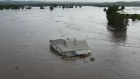 A Taree house floating away in the flood.