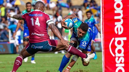 Reds winger Suliasi Vunivalu (left) trips Fijian Drua’s Kitione Salawa during Queensland’s loss in Suva.