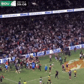 Fans rush the field as Alex Johnston breaks the NRL try-scoring record.