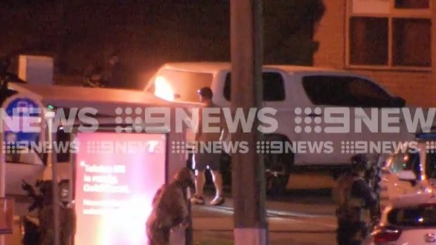 The end of a tense standoff at a Gold Coast service station overnight as a man surrenders to police.