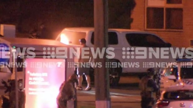 The end of a tense standoff at a Gold Coast service station as the man surrenders to police.