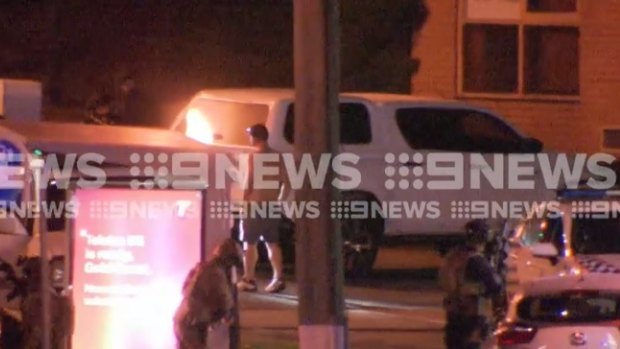 The end of a tense standoff at a Gold Coast service station overnight as the man surrenders to police.