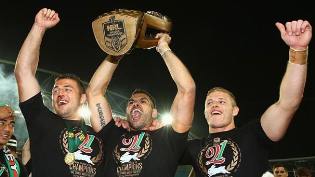 Sam Burgess (left), Greg Inglis (centre) and George Burgess (right) of the Rabbitohs celebrate with the trophy after victory after beating the Canterbury Bulldogs to win the 2014 NRL Grand Final match at ANZ Stadium on October 5.
