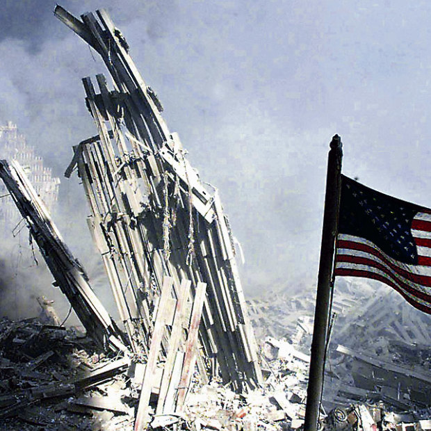 Am American flag flies near the base of the destroyed World Trade Center in New York, September 11, 2001.