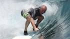 Grant Thornton CEO Greg Keith surfing off the Telos Islands in Indonesia.