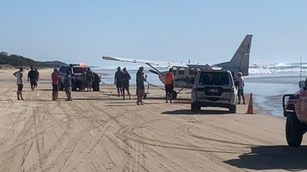 The light plane made a "low-impact" landing on Fraser Island and became bogged, according to paramedics.