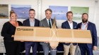 Defence Minister Richard Marles (centre) with SYPAQ team members and one of the cardboard drones.