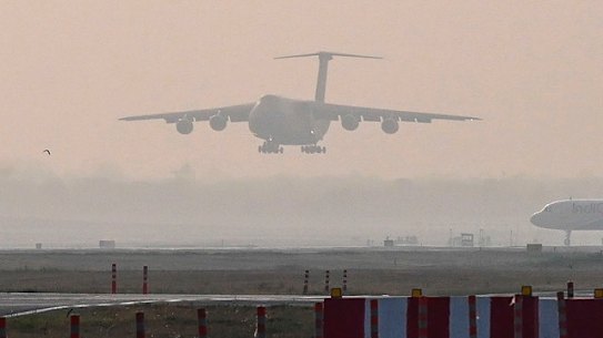 An US Air Force aircraft carrying relief supplies from the United States in the wake of India’s COVID-19 situation prepares to land at the Indira Gandhi International Airport in Delhi, India. 