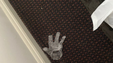 A discarded glove Mr de Kretser found on the floor of his dirty hotel room.