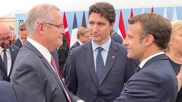 Prime Minister Scott Morrison speaks to Canadian Prime Minister Justin Trudeau (centre) and French President Emmanuel Macron (right) in Portsmouth.