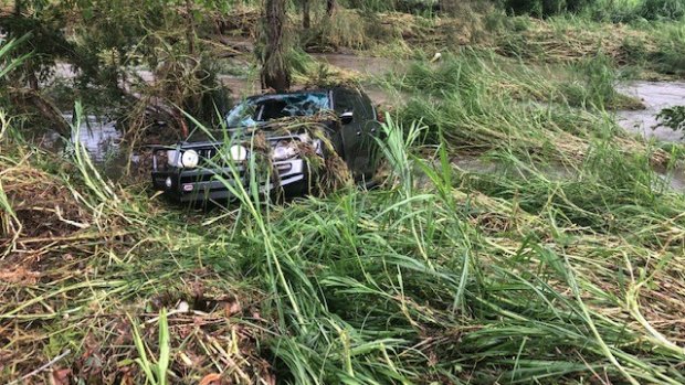 A car swept off the road by floodwater in the Mackay region.